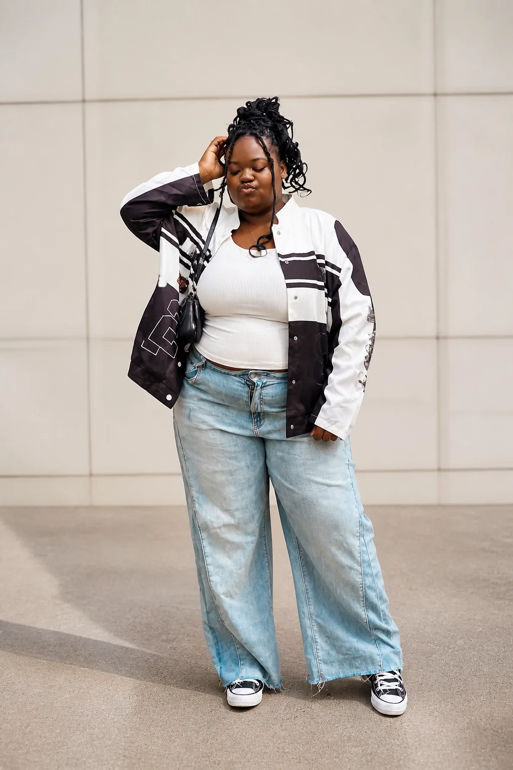 Casual varsity jacket and wide-leg denim look
